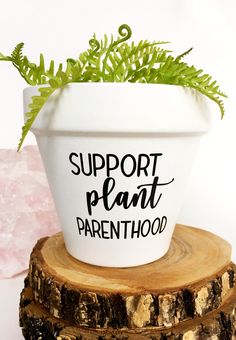 a potted plant sitting on top of a tree stump with the words support plant parenthood