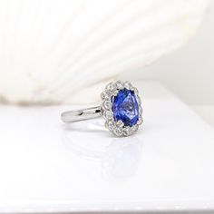 This beautiful ring features a 3.20 carat cushion cut Tanzanite gemstone with natural earth mined diamonds in solid 14K gold. This Tanzanite ring makes a lovely December birthstone gift for your loved ones! This ring is made with solid 14K Gold and natural Earth mined SI / G-H diamonds. As listed, this ring is ready to ship. If you're interested in purchasing this setting with a different center stone please message us! Oval Sapphire Gemstones In Halo Setting, Cushion Cut Diamond Gemstones For Fine Jewelry, Elegant Cushion Cut Gemstone With Center Stone, Cushion Cut Diamond Fine Jewelry, Elegant Cushion Cut Gemstones, Fine Jewelry Cushion Cut Gemstone With Center Stone, Tanzanite Cushion Cut Ring With Brilliant Detail, Classic Cushion Cut Gemstone For Anniversary, Oval Sapphire Gemstone With Halo Setting