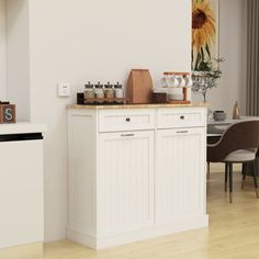 a kitchen with white cabinets and wood flooring next to a dining room table filled with chairs