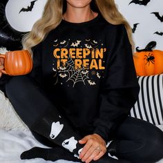 "🦇 Embrace the spooky season with our \"Creepin' It Real\" unisex crew neck sweatshirt! 🕷️ This Halloween-inspired sweatshirt is the perfect way to showcase your love for all things eerie and mysterious. With bats and spider webs surrounding the distressed-style text, you'll be ready to keep it real in style this October. 🎃 Sweatshirt Details: -Material: A cozy blend of 50% cotton and 50% polyester for maximum comfort -Medium-heavy fabric (8.0 oz/yd² or 271.25 g/m²) ensures warmth and durabil Creepin It Real, Sweatshirt Details, Spider Webs, Comfortable Sweater, Keep It Real, Spooky Halloween, Womens Fall, Spooky Season, Casual Fall