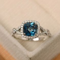 This ring features a 7*7 mm cushion cut london blue topaz. Customization is available. It is made by hand, and it will take about 7 days to finish the ring after your payment is completed. Main stone: 7*7 mm cushion cut Main stone weight:2.20 ct Metal type: sterling silver /14k gold Accent stone: cz Customization is available, just fee free to contact me, it is free to engrave inside the ring, it is free, you can leave a ntoe with your order, but it will be great no more than 15 letter. Any ques Original Engagement Rings, Fashion Rings Silver, Engagement Ring Prices, Ring Cushion, Silver Engagement Ring, Cushion Cut Ring, London Blue Topaz Ring, Blue Stone Ring, Cushion Ring