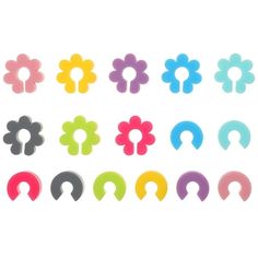 an assortment of different colored flower shaped ear tips on a white background with clippings