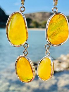 Earrings material and details : * Natural Amber and Sterling Silver  * Stone : Natural Landscape Baltic Amber * Silver hallmark :Ag 925 * Weight: 22,0 g * Earrings length : 8,3 cm * Stone dimensions : 6,6*~1,0-2,2*0,6 cm  * Color : White, yellow Yellow Dangle Earrings For Jewelry Making, Amber Dangle Earrings, Hypoallergenic Amber Dangle Earrings, Amber Dangle Pierced Earrings, Amber Dangle Earrings In Baltic Amber, Baltic Amber Drop Earrings, Yellow Sterling Silver Drop Earrings, Unique Yellow Baltic Amber Jewelry, Amber Dangle Earrings, Pierced