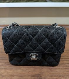 This CHANEL Mini Quilted Black Caviar Flap Bag is a must-have for any fashion-forward woman. The bag features a solid pattern and is made of high-quality leather with a gold hardware color. The bag has a turn lock closure and a black leather handle/strap with metal accents. The bag is 7 inches wide and 3 inches deep, making it the perfect size for carrying your essentials. The bag comes with an authentication card and features inner pockets, a chain strap, and pockets. The unicorn theme adds a touch of fun to the bag, making it perfect for any occasion. This bag is part of the CHANEL Mini product line and is sure to impress. Please let me know if you would like additional pictures or have any questions. Shipped with insurance and signature. Chanel Mini, Unicorn Theme, Black Caviar, Metal Accents, Mini Quilt, Metallic Accents, Solid Pattern, Flap Bag, High Quality Leather