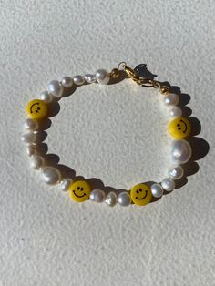 Cute and happy bracelet made of freshwater pearls and smiley faces beads. Perfect as a gift or to treat yourself  Size is 17 cm but if you want a different size just let me know! Thank you for stopping by and don't forget to check my shop for more unconventional jewelry  Have a wonderful day  Veronica Handmade Cheerful Jewelry For Friendship, Cheerful Handmade Jewelry For Friendship, Cheerful Handmade Jewelry Gift, Smiley Face Round Beads Bracelet For Gift, Smiley Face Round Beads Bracelet As Gift, Handmade Cheerful Bracelet Jewelry, Trendy Handmade Pearl Bracelet For Friendship, Trendy Handmade Pearl Bracelet, Cheerful Handmade Bracelets As A Gift