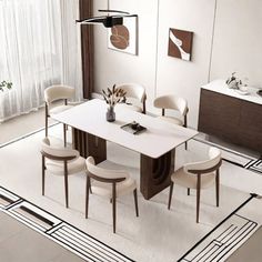 a dining room table with four chairs and a rug on the floor in front of it