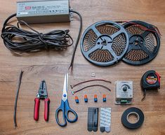 various tools are laid out on the floor to be used for electrical repairs and repair