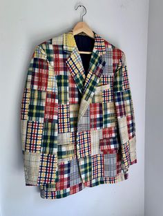 This amazing mens blazer from the 80's is so high quality.  Tailor made with posh details in the lining, this fits like a 44 regular. This is a posh coat in good condition.  One of the plaid swatches on the front bottom looks to have the red dye running a bit - not noticeable at all and might rectify with a good dry cleaning.   Measures 22" flat across the chest and is 30" long.  Sleeves are 23.5" from shoulder to cuff. Plaid Single Breasted Sport Coat With Lapel Collar, Plaid Single-breasted Sport Coat With Lapel Collar, Tailored Plaid Sport Coat For Spring, Spring Tailored Plaid Sport Coat, Winter Cotton Sport Coat With Suit Collar, Tailored Plaid Sport Coat With Long Sleeves, Plaid Single Breasted Sport Coat For Spring, Plaid Single-breasted Sport Coat For Spring, Business Plaid Cotton Outerwear