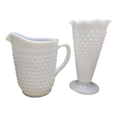 two white vases sitting next to each other