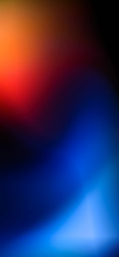 an abstract background with blue, red and yellow colors in the center is blurry