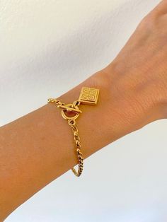 Vintage Givenchy toggle charm bracelet.  One side of the charm is the signature Givenchy 4Gs logo and the other side has 4 colorful stones in a square (dark red, golden, sapphire blue, green). In beautiful condition. The bracelet is a generous 7.5" long. It can be easily shortened by removing links of the chain. If you would like it delivered already shortened to your desired length, please send a message with your order. A perfect gift to yourself, or a loved one. A true treasure. Please note: Luxury Charm Bracelet With Logo Charm As Gift, Luxury Logo Charm Bracelet As Gift, Gold-tone Bracelet With Logo Charm As Gift, Metal Bracelet With Logo Charm, Adjustable Logo Charm Bracelet, Metal Bracelet With Logo Charm As A Gift, Metal Bracelets With Logo Charm As Gift, Metal Charm Bracelet With Logo For Gift, Metal Charm Bracelet With Logo As Gift