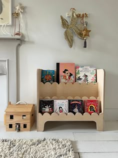 there is a book rack with many books on it next to a rug and clock