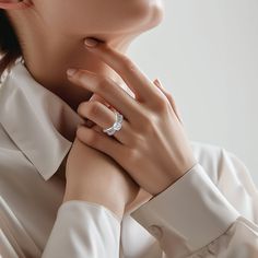 a woman wearing a diamond ring on her neck