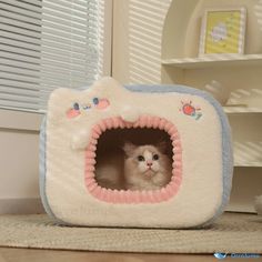 a cat is sitting in a kitty house