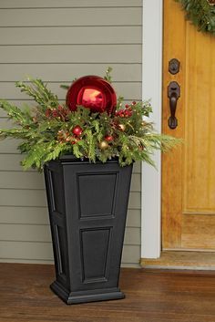 a black planter filled with christmas decorations