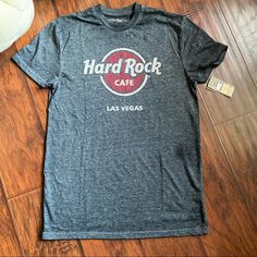 Happy Holidays Merry Christmas Perfect Gift For The Hard Rock Collector Las Vegas Hard Rock T-Shirt New With Tags Bought For $34.50 But Will Not Use It, My Loss Your Gain Size Ym (Woman’s Small) I Bought This Thinking It Was A Woman’s Medium. It Was Misplaced In The Adult Section And T-Shirt Says “Medium”. I Got Home, From Vacation, I Tried It On And It Felt A Bit Tight Around The Chest (I’m 38dd). I Checked The Tag, It’s Ym. I Think If You’re A B Cup (Chest) Or A Small, This Will Fit You. Casual Tri-blend Tops With Band Logo, Rock Style Logo Print Crew Neck Top, Casual Band Logo T-shirt, Rock Style Crew Neck Top With Logo Print, Rock Style Fan Merchandise Top With Short Sleeves, Barcelona T Shirt, Mint Tee, Band Tee Shirts, Rock T Shirt