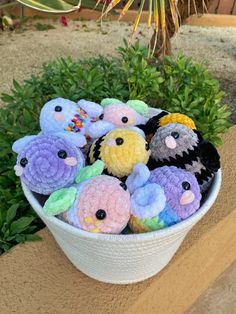 a white bowl filled with small stuffed animals