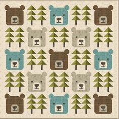 a bear themed quilt with trees and bears on the front, in shades of brown, blue, and green