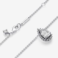 Shine bright every day with the Sparkling Pear Halo Collier Necklace. This sterling silver necklace combines the reimagined pear shape with an iconic element of the Pandora Timeless collection: the pavé halo. The stone of the pendant is set with one V-shaped and two elongated prongs to emphasize the shape, offering a beautiful play on dimension. The pear-shaped pendant slides freely on the chain and can be adjusted in length. A shining statement on its own or beautiful layered with other chains, this pendant effortlessly combines sparkling stones with timeless design. - Pandora Sparkling Pear Halo Collier Necklace - Sterling silver / Cubic Zirconia / Clear - Sz. 17.7 in Timeless Silver Diamond Necklace With Teardrop Pendant, Timeless Silver Necklace With Sparkling Stones, Timeless Silver Teardrop Diamond Necklace, Silver Solitaire Necklace With 17 Jewels, Silver Teardrop Diamond Necklace In Sterling Silver, Silver Teardrop Diamond Necklace With Dazzling Style, Dazzling Silver Teardrop Diamond Necklace, Silver Drop Necklace With Brilliant Cut, Silver Drop Necklaces With Brilliant Cut