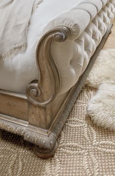 an antique style bed with white linens and pillows