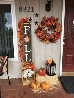 a fall front porch decorated with pumpkins and hay