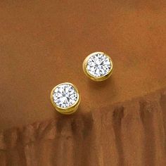 Ross-Simons - 1.00 ct. t. w. Bezel-Set Diamond Stud Earrings in 14kt Yellow Gold. Classic stud earrings get a contemporary update hosted in 14kt yellow gold bezels. Featuring 1.00 ct. t. w. round brilliant-cut diamonds, this scintillating pair is a must. Post/clutch, diamond stud earrings. Diamond birthstones are the perfect gift for April birthdays. Elegant Gold Diamond Earrings With Tension Setting, Gold Diamond Earrings With Tension Setting For Anniversary, Anniversary Cubic Zirconia Diamond Earrings With Tension Setting, Elegant Yellow Gold Diamond Earrings With Tension Setting, Formal Cubic Zirconia Earrings With Tension Setting, 14k Gold Tension Setting Earrings For Anniversary, 14k Gold Earrings With Tension Setting For Anniversary, Gold Diamond Earrings With Tension Setting, Elegant Diamond Earrings For Anniversary With Tension Setting