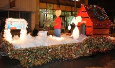 a parade float decorated with christmas lights and decorations