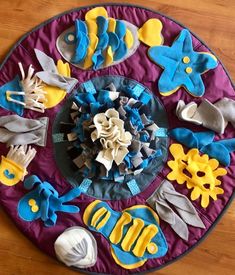 a circular tray with various decorated items on it, including seashells and seahorses