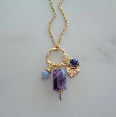 "~ ♦ ~ Higher Love Crystal Necklace ~ ♦ ~ ~ ♦ ~ Feel the energy of Universal & Angelic Love with these magical gemstones ~ ♦ ~ Details: * 15x10mm Chevron Amethyst Tube handcrafted paddle pendant * 6mm Faceted Lapis Rondelle * 6mm Angelite Rounds * Gold Heart Charm * 16mm Gold Twisted Circle * Gold Stainless Steel Cable Chain * Gemstone Drop measures 1.75\" (50mm) * Angelite brings the spiritual energies of power, healing, love, and protection. Wearing this stone is believed to have a calming eff Purple Amulet Necklaces As Gifts, Spiritual Blue Jewelry With Heart Charm, Purple Amulet Jewelry As A Gift, Purple Amulet Jewelry As Gift, Purple Amulet Style Jewelry Gift, Handmade Heart-shaped Jewelry For Meditation, Bohemian Heart Jewelry For Everyday, Personalized Purple Heart Jewelry, Purple Bohemian Everyday Jewelry