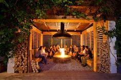 a group of people sitting around a fire pit