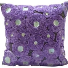 a purple pillow with white polka dots on it