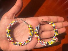 This is a beautiful, colorful Indian beaded pair of earrings that will pair well with your Indian or Western outfit. This is a beautiful, intricately designed pair with spiraled beads around the earrings. The beads are red, blue, yellow, white, pink, black and red. These are handmade, so there may be slight imperfections in the pair. Each hoop measures about 6 cm across the earring.  Add a splash of colour to your outfit with this fun pair of earrings! Perfect for an Indian outfit or a western o Multicolor Hoop Earrings With Round Beads, Colorful Beaded Round Hoop Earrings, Handmade Colorful Beaded Round Earrings, Handmade Multicolor Traditional Hoop Earrings, Multicolor Hoop Earrings With Tiny Beads, Bohemian Multicolor Hoop Earrings, Traditional Multicolor Hoop Earrings For Festivals, Handmade Traditional Multicolor Hoop Earrings, Traditional Handmade Multicolor Hoop Earrings