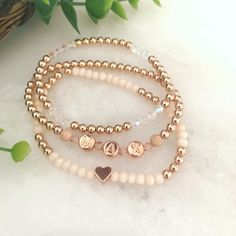 "BLUSH STACK 🌸 3 BRACELETS  * high quality metal spacer beads available in 14k gold fill, or 14k rose gold fill  * rose crystals & stardust accents  * peach faceted oval beads & small heart shape charm  * iridescent crystals 🌷Rose Gold option comes with 14k rose gold filled round beads, rose gold letters, rose gold stardust beads on sides of letter beads & rose gold colored heart 🌻Gold option comes with 14k gold filled round beads, white with gold letters, gold stardust beads on sides of lett Dainty Beaded Name Bracelet For Everyday, Elegant Gold Beaded Bracelet With Custom Name, Customized Rose Gold Jewelry For Mom, Customized Rose Gold Jewelry Gift For Mom, Stackable Rose Gold Bracelets In 14k Gold Filled, Rose Gold Beaded Bracelets As Gift, Dainty Beaded Name Bracelet, Elegant Personalized Rose Gold Beaded Bracelets, Dainty Rose Gold Name Bracelet