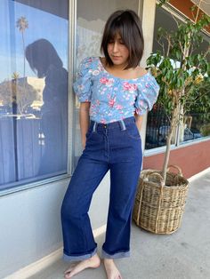 Puffy sleeve hand made floral print blouse with buttons at front and on sleeves. Pastel blue with rose and foliage print. Fabric: Cotton Fit: xs|sEra: 1980’s Measurements: Bust 36" Sleeve (from collar) 14.5" arm width 5” (flat) Length 22.5" Waist 31" Condition: Excellent Vintage Puff Sleeve Top For Spring, Vintage Floral Print Blouse With Puff Sleeves, Vintage Puff Sleeve Blouse With Floral Print, Vintage Puff Sleeve Top, Vintage Blue Tops With Floral Print, Reworked Denim Jeans, Reworked Jeans, Blouse With Buttons, Foliage Print