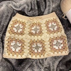 a crocheted purse sitting on top of a blanket