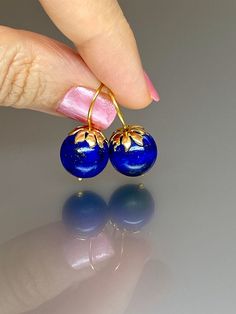 Beautiful vibrant and high-grade lapis lazuli globe earrings. The 12.5 mm lapis lazuli globes have a gorgeous deep vibrant royal blue color that shows celestial flecks of golden pyrite in the stone. The ultra-fine globes attached to a beautiful 14K gold-filled flower caps as they attached the vermeil on sterling ear wires. These are elegant and perfect earrings to go with any outfit. A pair of fine gemstone essentials. *Ball size (diameter): 12.5 mm *Metal: vermeil on sterling *Earrings drop len Round Lapis Lazuli Gemstone Earrings, Elegant Lapis Lazuli Earrings With Natural Stones, Handmade Round Lapis Lazuli Earrings, Blue Lapis Lazuli Earrings For Formal Occasions, Blue Lapis Lazuli Earrings, Pierced Lapis Lazuli Round Jewelry, Elegant Lapis Lazuli Earrings For Gift, Elegant Lapis Lazuli Earrings As A Gift, Royal Blue Lapis Lazuli Round Jewelry