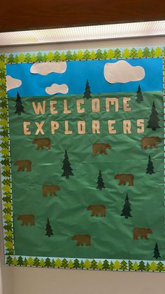 a bulletin board with the words welcome explorers written on it and bears in the background