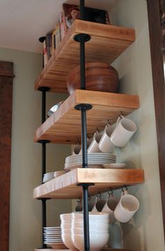 the shelves are filled with dishes and cups