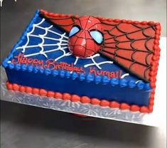 a birthday cake with a spiderman face on it