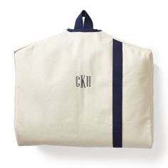 a white canvas bag with blue trim and initials on it