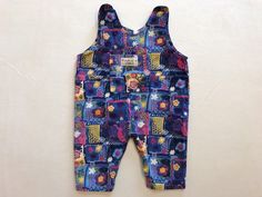 "Adorable 90s Floral overalls by Playmates clothing co 100% cotton. Made in Canada. Snaps at the saddle for easy changing.  Tagged size XS Pit to pit 13\" Top of shoulder strap to saddle 15\"  Inseam 6\" In good preowned vintage condition." Casual Cotton Shortalls For Playwear, Fun Cotton Overalls For Playtime, Vintage Cotton Overalls For Playtime, Sleeveless Cotton Overalls For Playtime, Fitted Cotton Jumpsuits And Rompers For Playtime, Fitted Cotton Bib Front Shortalls, Retro Multicolor Cotton Jumpsuits And Rompers, Canada Snaps, Vintage Baby Boy Clothes