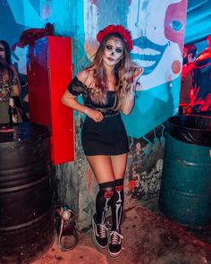 a woman with makeup and skeleton make - up posing for a photo