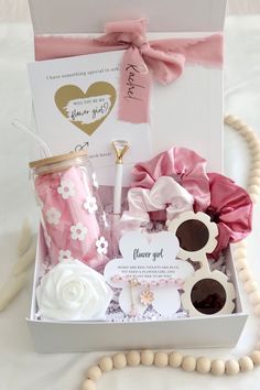 a gift box filled with pink and white items