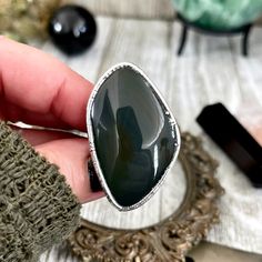 Size 9 Natural Grey Rainbow Obsidian Ring in Fine Silver/ Foxlark Collection - One of a Kind -A beautiful piece of Obsidian Set in fine silver. Ring size 8 Ring Length 1.6" -Each piece is made by me in my home studio. All items come ready for gift giving in a recycled kraft paper jewelry box. -Our silver jewelry is created by a unique precess. First forming a thick layer of copper to create an organic look and texture and then each piece is encased in a extra thick layer of pure fine silver to c Elegant Obsidian Jewelry For Healing, Silver Onyx Jewelry With Large Stone, Silver Obsidian Jewelry For Healing, Obsidian Ring, Rainbow Obsidian, Paper Jewelry, Home Studio, Kraft Paper, Fine Silver