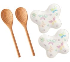 two wooden spoons with butterfly designs on them