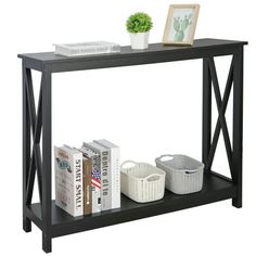 a shelf with books, baskets and pictures on it next to a potted plant