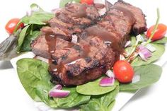 steak and salad on a plate with a fork