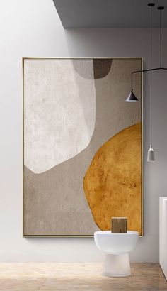 an abstract painting hangs on the wall next to a white toilet in a modern bathroom