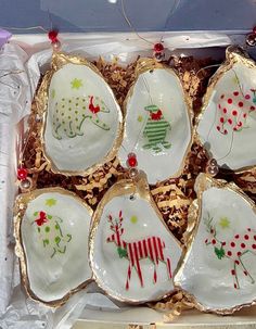 six christmas ornaments in a box on display