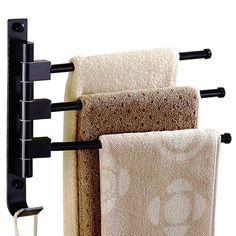 two towels are hanging on a towel rack with black brackets and one is holding three folded towels